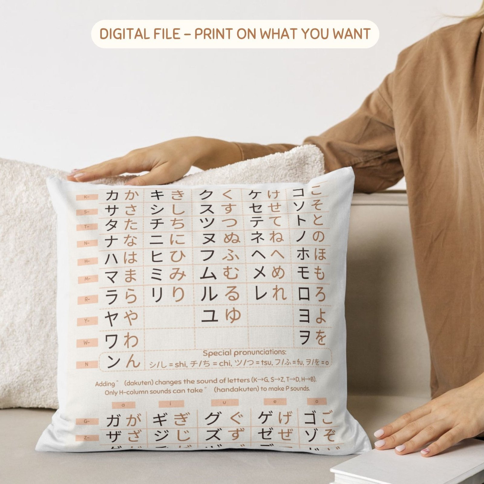 Japanese hiragana katakana alphabet chart printed on decorative white pillow in cozy home setting